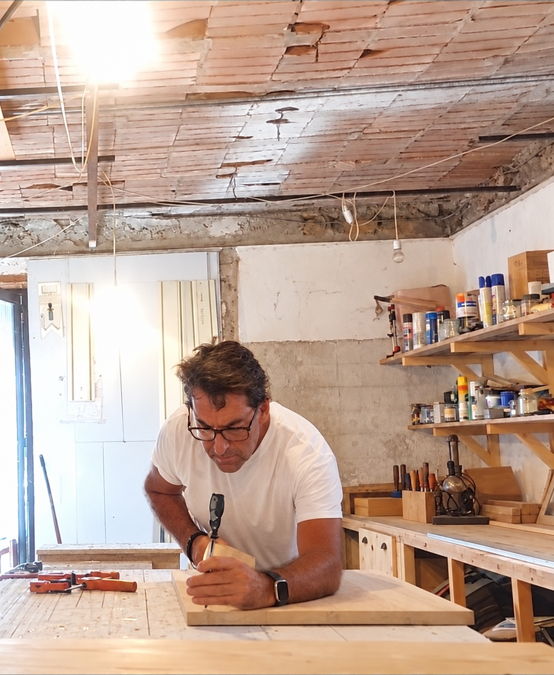 Rich Neads working on timber at the bench in his Umbrian workshop